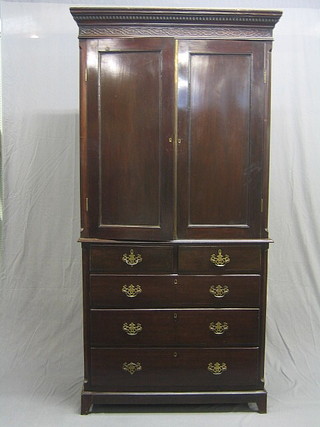 A 19th Century mahogany linen press, the top with moulded and dentil cornice and blind fret work frieze, the interior fitted a shelf, the base fitted 2 short and 3 long drawers, raised on bracket feet 41"