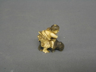 A 19th Century carved Japanese Netsuke in the form of a figure astride an animal (legs broken)