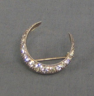 A lady's handsome Victorian crescent shaped brooch set approx 24 diamonds