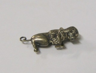 A "silver" articulated charm in the form of a seated dog