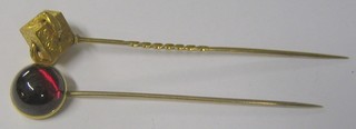 A "gold" stick pin and a stick pin set a cabouchon cut red stone (2)