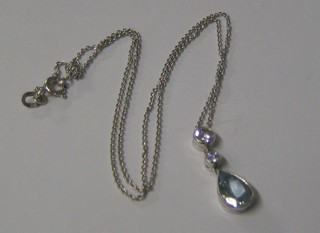 A lady's handsome white gold pendant set a tear cut aquamarine surmounted by 2 diamonds (approx 0.30/1.10ct)