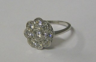 A lady's 18ct white gold floral design dress ring set 9 diamonds (approx 1.42 ct)