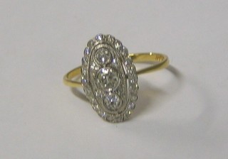 A lady's 18ct white gold pierced marquise shaped dress ring set 3 diamonds to the centre surrounded by numerous diamonds (approx 0.65ct)