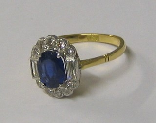 A lady's very attractive 18ct gold dress ring set an oval cut sapphire supported by 2 baguette cut diamonds and 10 diamonds (approx 0.45/3.43ct)