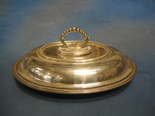 A silver plated entree dish and cover 
