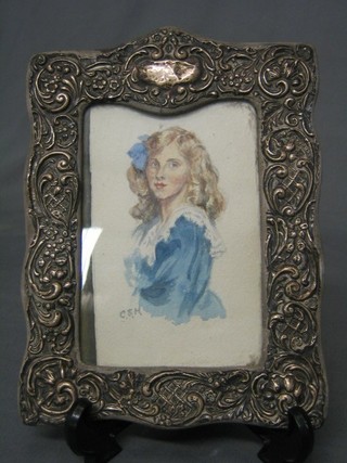 An Edwardian embossed silver easel photograph frame (some holes) containing a half length portrait of a lady 8"