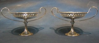 A pair of circular pierced silver plated bon bon dishes