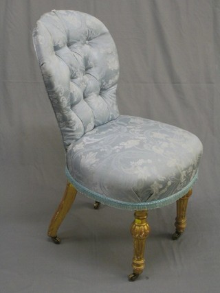 A 19th Century French gilt painted show frame boudoir chair upholstered in buttoned blue material