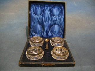 4 circular cut glass salts with silver mounts, cased
