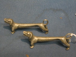 A pair of pewter knife rests in the form of Dachshund