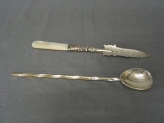 A silver bladed butter knife with engraved blade and mother of pearl handle together with a modern silver cocktail/jam spoon with spiral turned handle