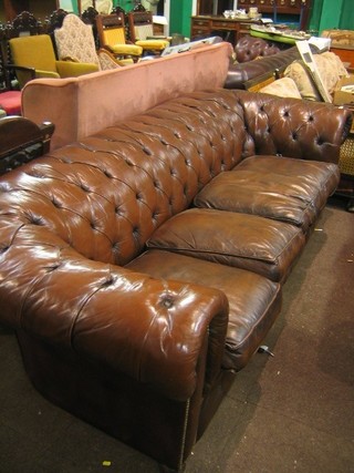 Ensuite with the aforementioned lot, a 4 seat Chesterfield upholstered in brown buttoned back hide, 96"