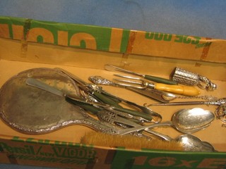 A silver backed hand mirror, do. clothes brush, 2 silver plated serving spoons, a bread fork and other items