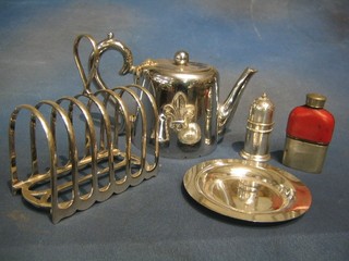 A circular silver plated tea pot decorated a Fleur de Lis, a 7 bar toast rack, a silver plated dish, a small hip flask and a silver plated coffee pot