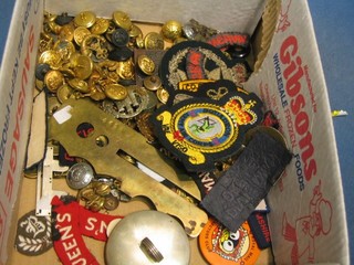 A collection of military buttons and cloth insignia