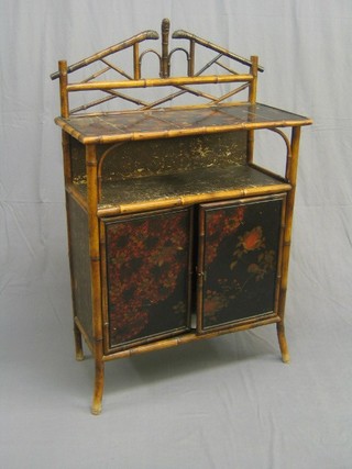 A bamboo chiffonier with raised back, the base fitted a cupboard enclosed by a panelled door, 32"
