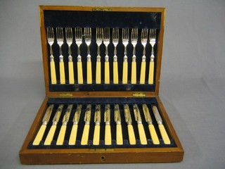 A set of 6 19th Century silver plated fruit knives and forks in a walnut canteen