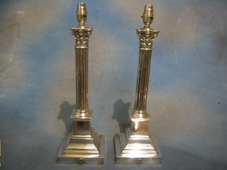A pair of reeded silver plated column table lamps with Corinthian capitals 17"