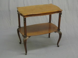 An Edwardian walnut shaped 2 tier occasional table, raised on carved cabriole supports 27"