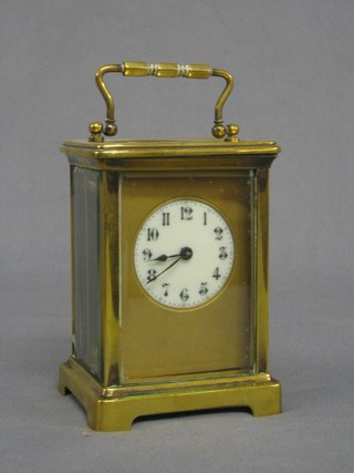 A 19th Century French 8 day carriage clock with circular porcelain dial and Arabic numerals contained in a gilt metal case (f)