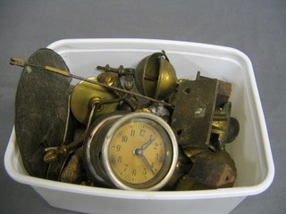 A large pendulum bob together with a collection of various metal clock finials etc