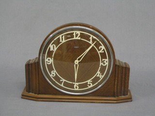 A Metamec Art Deco electric mantel clock with Arabic numerals contained in an oak case