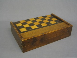 A 19th Century wooden folding chess set, the interior fitted a games board complete with drafts and chessmen 17"