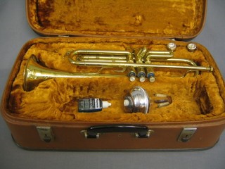 A brass 3 valved trumpet "The Corton" complete with mute and fibre carrying case