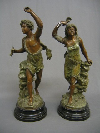 A pair of 19th Century spelter figures of standing boy and girl, raised on turned wooden bases, 22" (1 base f)