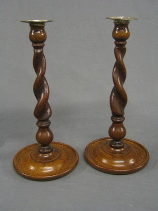 A pair of oak spiral turned candlesticks with silver plated sconces 14"