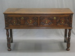 A Victorian Jacobean style oak dresser base fitted 2 drawers, raised on turned and block supports 55"