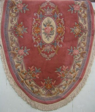 An oval pink and floral ground Chinese rug 96" x 61"
