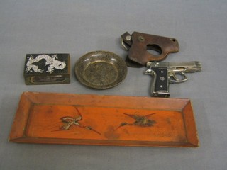 A cigarette lighter in the form of an automatic pistol, a cloisonne enamelled match slip, a small dish and a pen tray 
