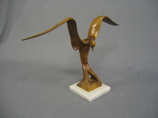 A carved wooden sculpture of a bird, raised on a marble base 20"