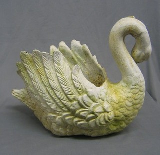 A cast iron planter in the form of a swan 20"