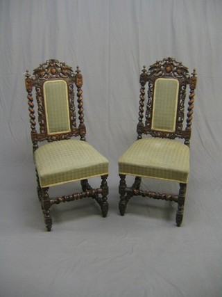 A set of 6 Victorian carved oak Carolean high back chairs with spiral turned decoration and upholstered seats and backs, raised on turned and block supports