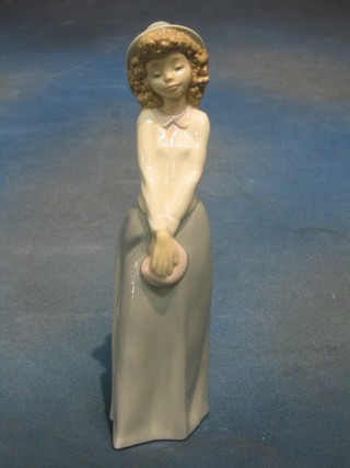 A Nao figure of a standing girl with purse 10"