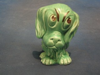 A Sylvac figure of a green glazed seated dog, the base marked RDN 1245 813261, 5"