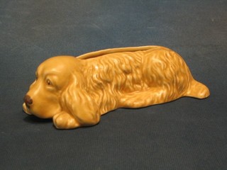 A Sylvac brown glazed planter in the form of a reclining dog, the base marked Sylvac England 2025 7"