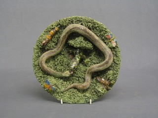 A 20th Century circular Portuguese plate decorated a snake and lizard 11" (damage to base)