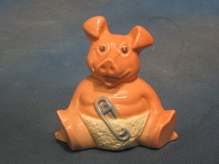 A "Wade" pottery piggy bank of a seated baby pig 5"