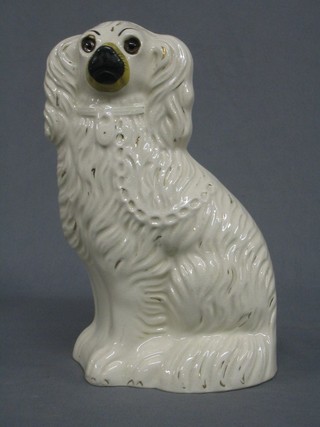 A Staffordshire style figure of a seated Spaniel with glass eyes 10"