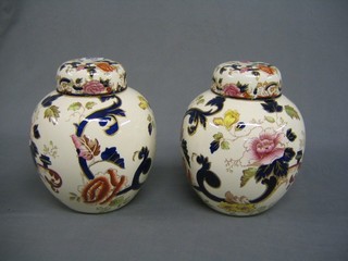 A pair of 20th Century Masons Imari pattern ginger jars and covers, the bases with red Masons mark, 9"