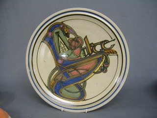 A Richard Ferris Orchard Pottery charger, decorated Celtic symbols 14"