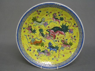 An Oriental yellow glazed porcelain bowl decorated dragons, the reverse with 6 character mark, 13"