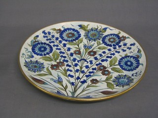 A Wood Clyffe pottery charger, the reverse with paper label marked Howell & James Art Pottery Exhibition 1890, exhibited by Mrs William Smith Wood Clyffe, title of piece "Persian Plate" 16"