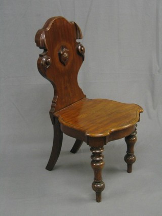 A Victorian carved mahogany hall chair with solid seat on turned supports