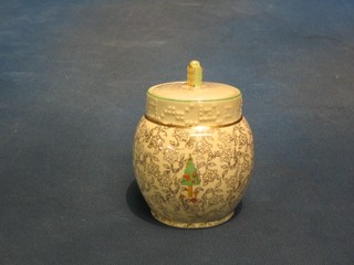 A circular Beswick preserve jar and cover decorated a stylised cottage 4"