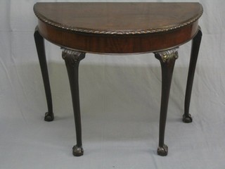 A 1920's Georgian style demi-lune card table with gadrooned border, raised on cabriole ball and claw supports 36" (light scratching to the top)